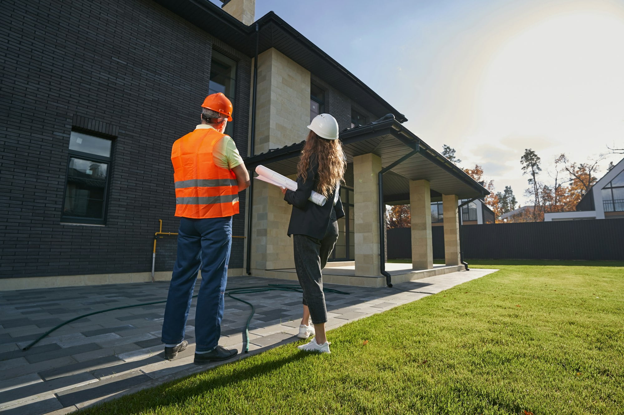 Engineer and worker checking out private house